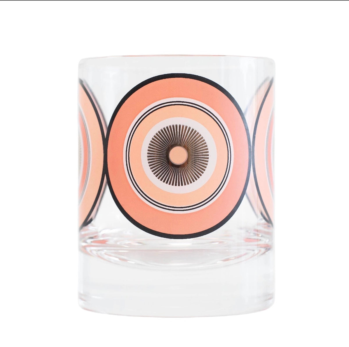 Clear 10 oz whiskey rocks glass with oversized pink and peach concentric circles, black detailing and gold starburst center