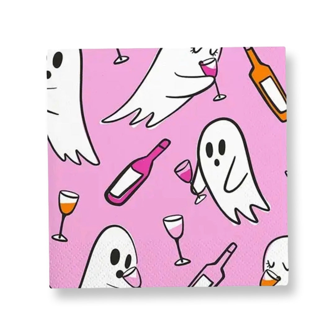 Pink Halloween cocktail napkins featuring white ghosts holding drinks with colorful wine bottles and cocktail glasses.