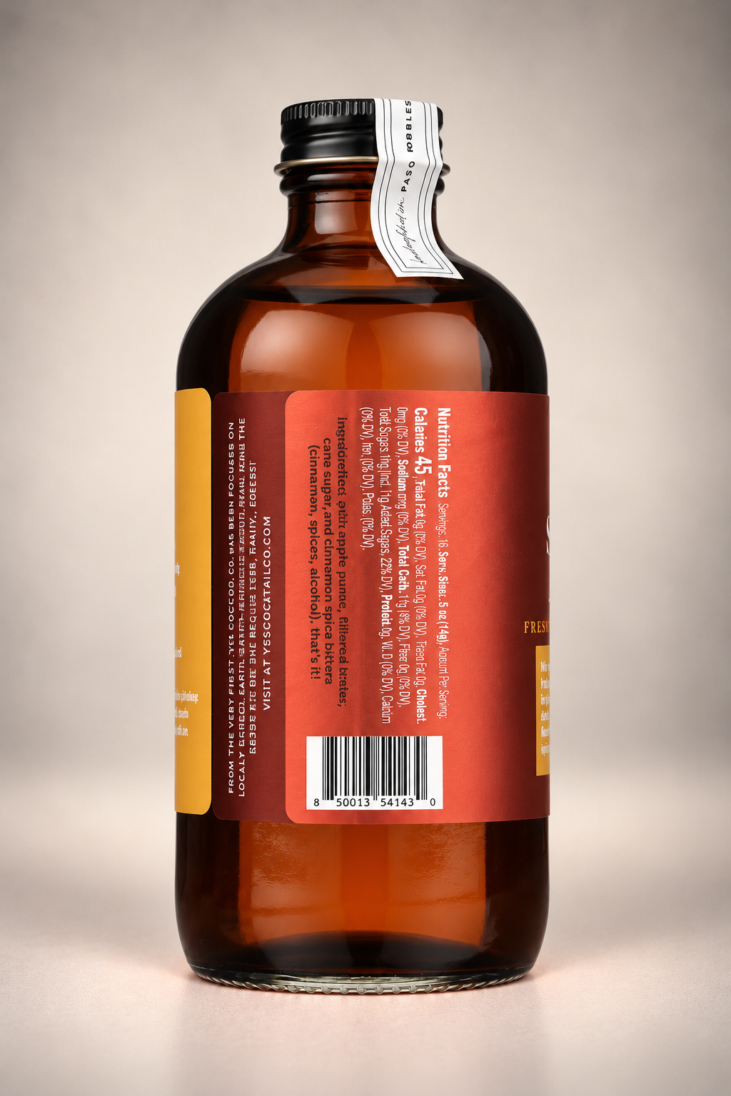 Side label of Yes Cocktail Co. Spiced Apple Syrup displaying ingredients, nutrition information, and product barcode on an 8 oz amber glass bottle.