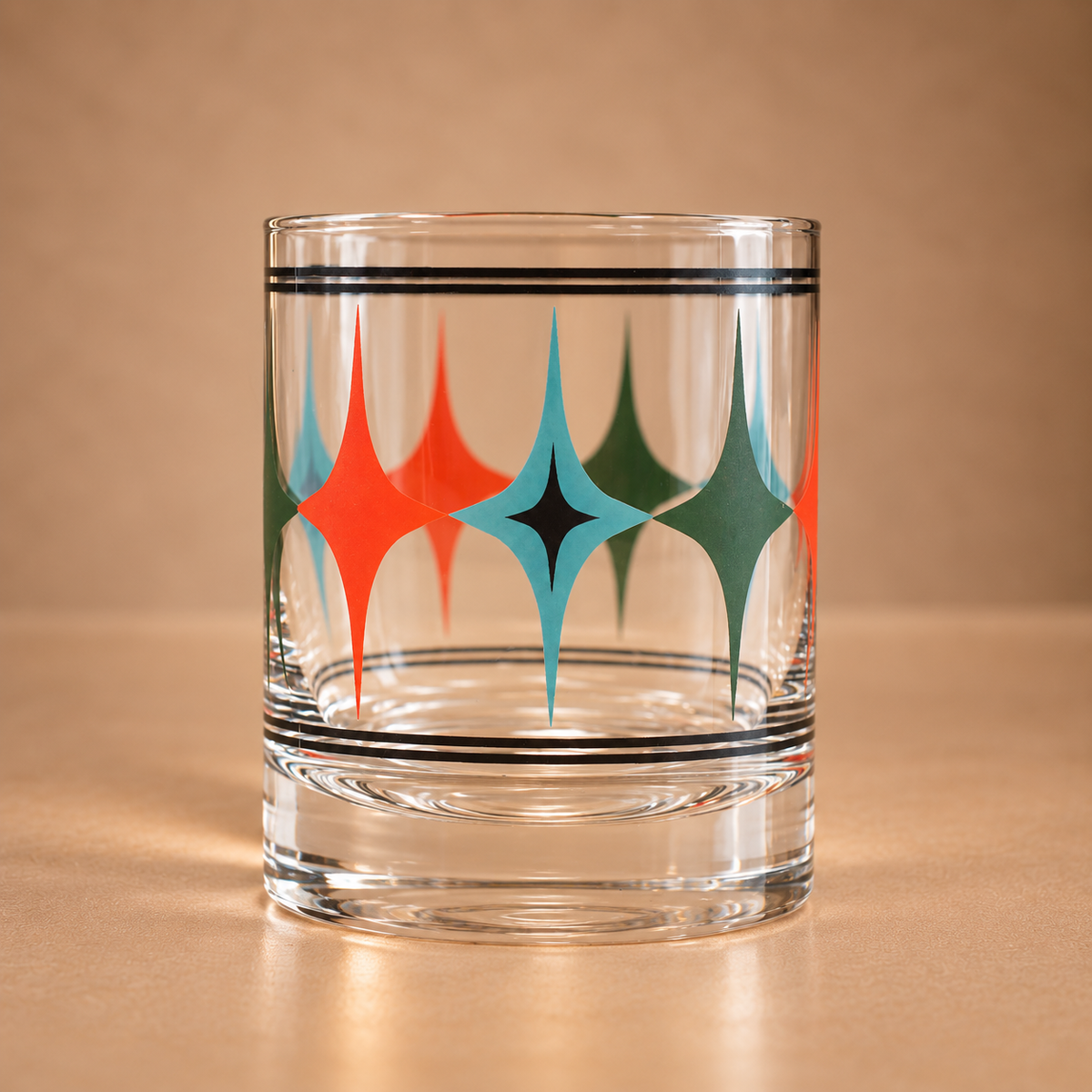 Clear 10 oz whiskey rocks glass with coral, turquoise, green and black mid century modern starlight diamond pattern