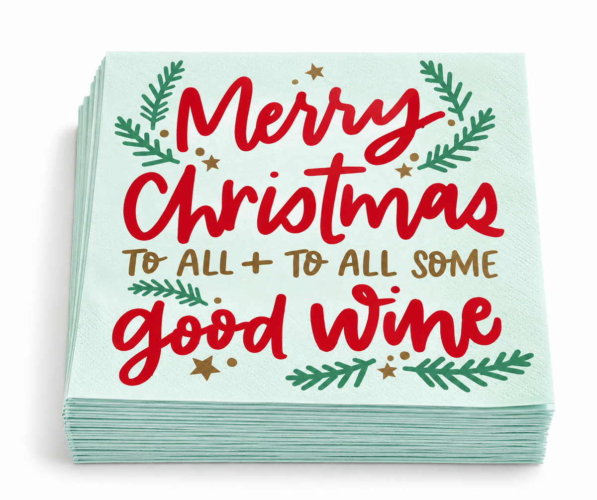 Stack of 20 mint green Christmas beverage napkins with red lettering, gold accents and evergreen branches.