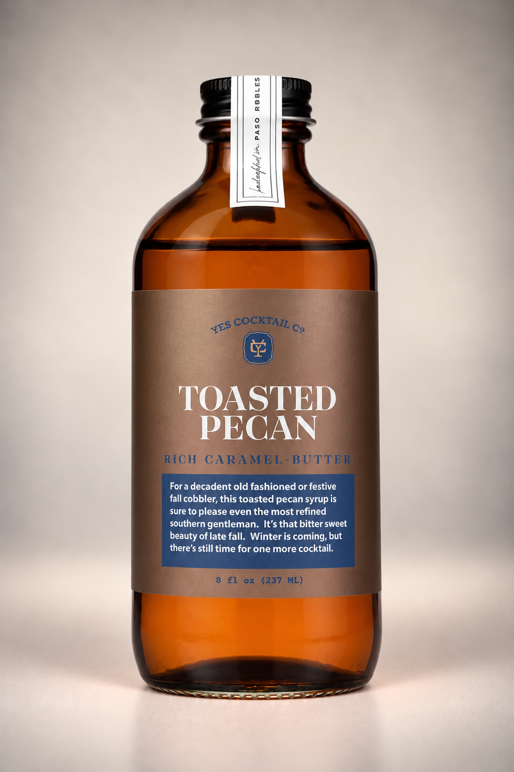 Front view of Yes Cocktail Co. Toasted Pecan Cocktail Syrup in an amber glass bottle with brown label, featuring rich caramel and buttery pecan flavor.