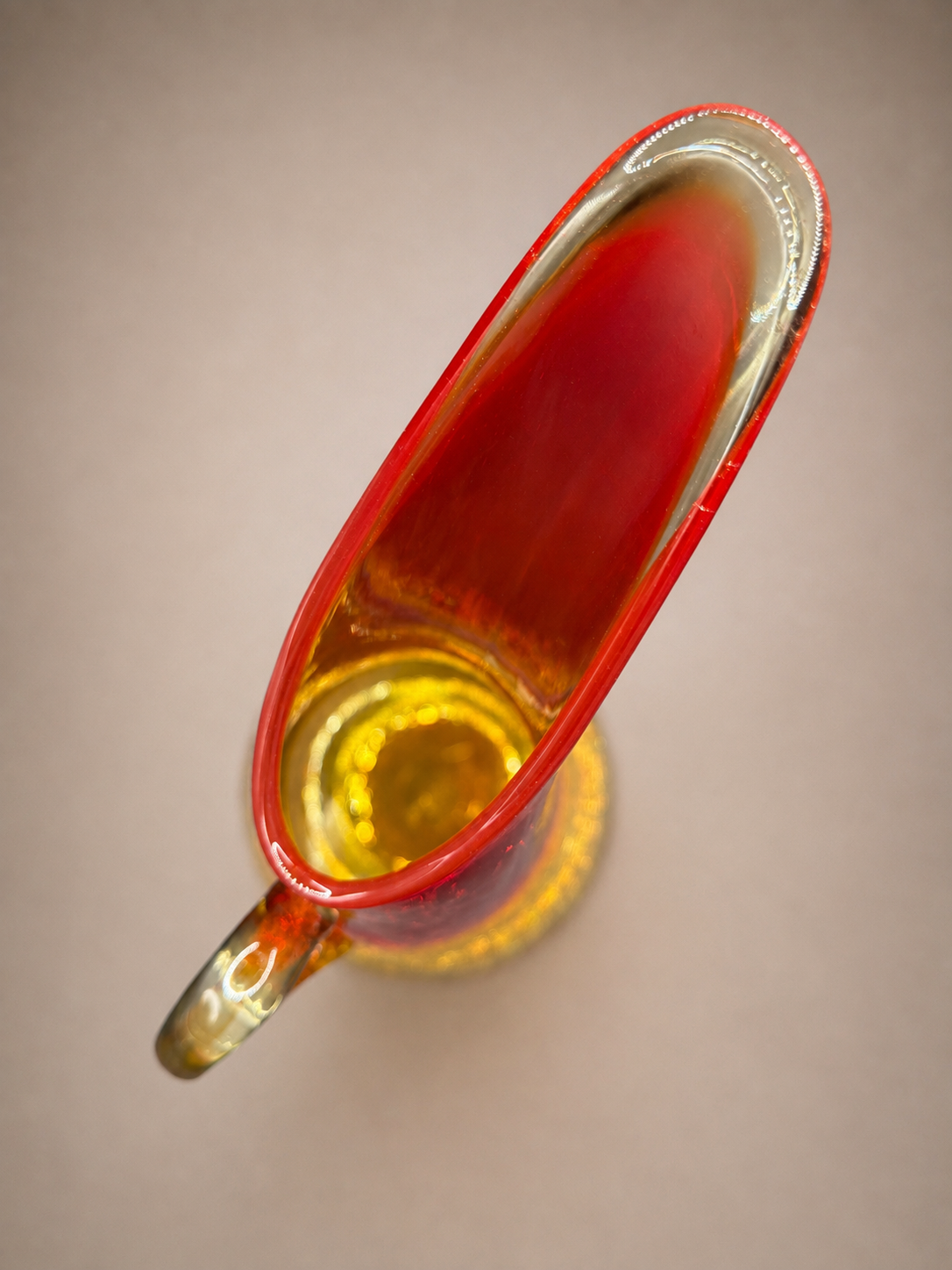 Overhead view highlighting the elongated asymmetrical spout and hand-formed opening of the Kanawha Glass pitcher.