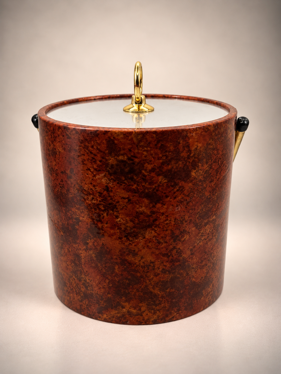 Rear view of vintage tortoiseshell-style ice bucket showing rich brown mottled pattern and gold-tone hardware.