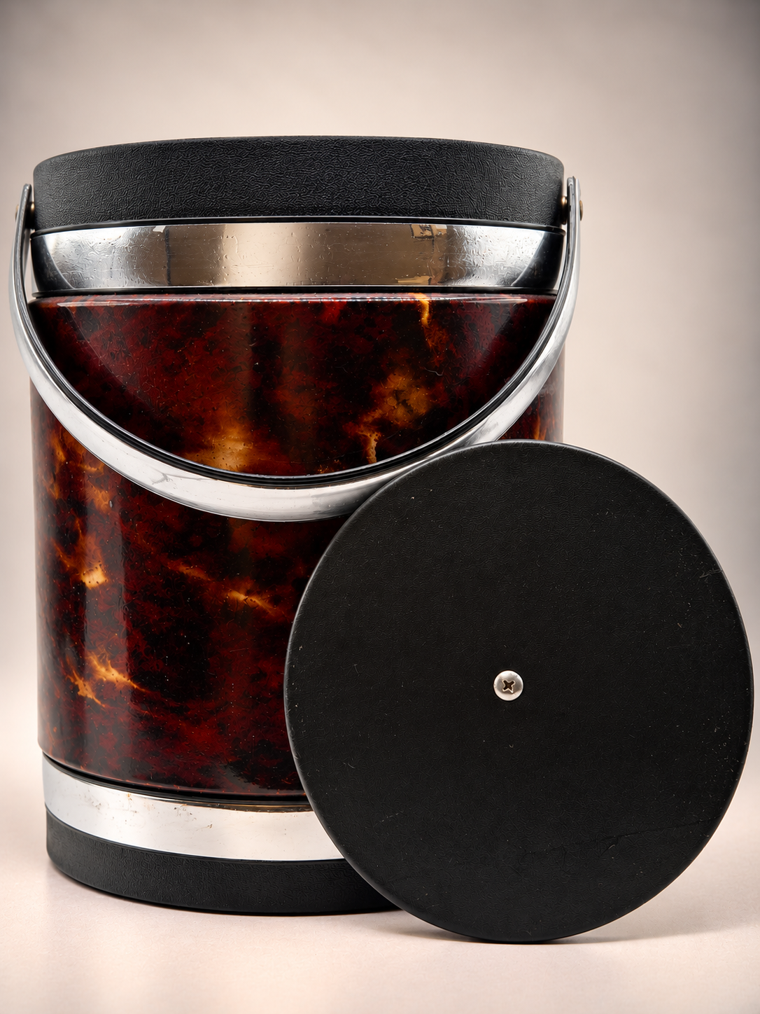 Vintage Elmar ice bucket with removable black lid positioned against its marbled brown exterior.