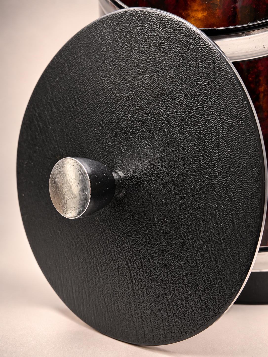 Close-up of removable Elmar ice bucket lid showing textured black surface and silver-tone knob with minor wear.