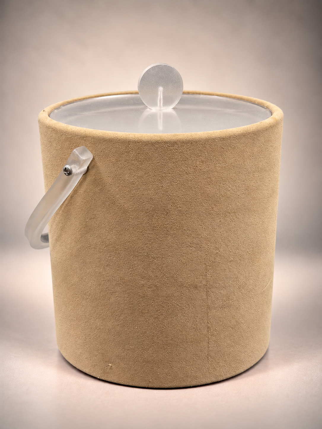 Vintage Georges Briard ice bucket with textured beige suede-look exterior, frosted acrylic handle, and translucent lid with round knob.