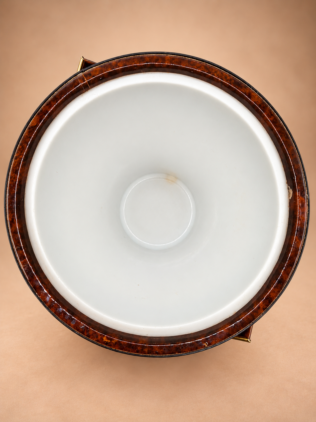Overhead view showing clean white insulated interior of vintage brown and gold ice bucket.