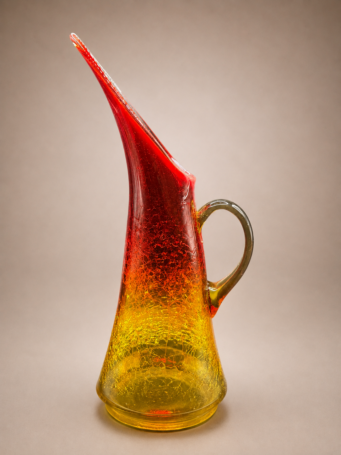 Side profile showcasing the elegant silhouette, crackle finish, and amber-to-red color gradient of the vintage art glass pitcher.