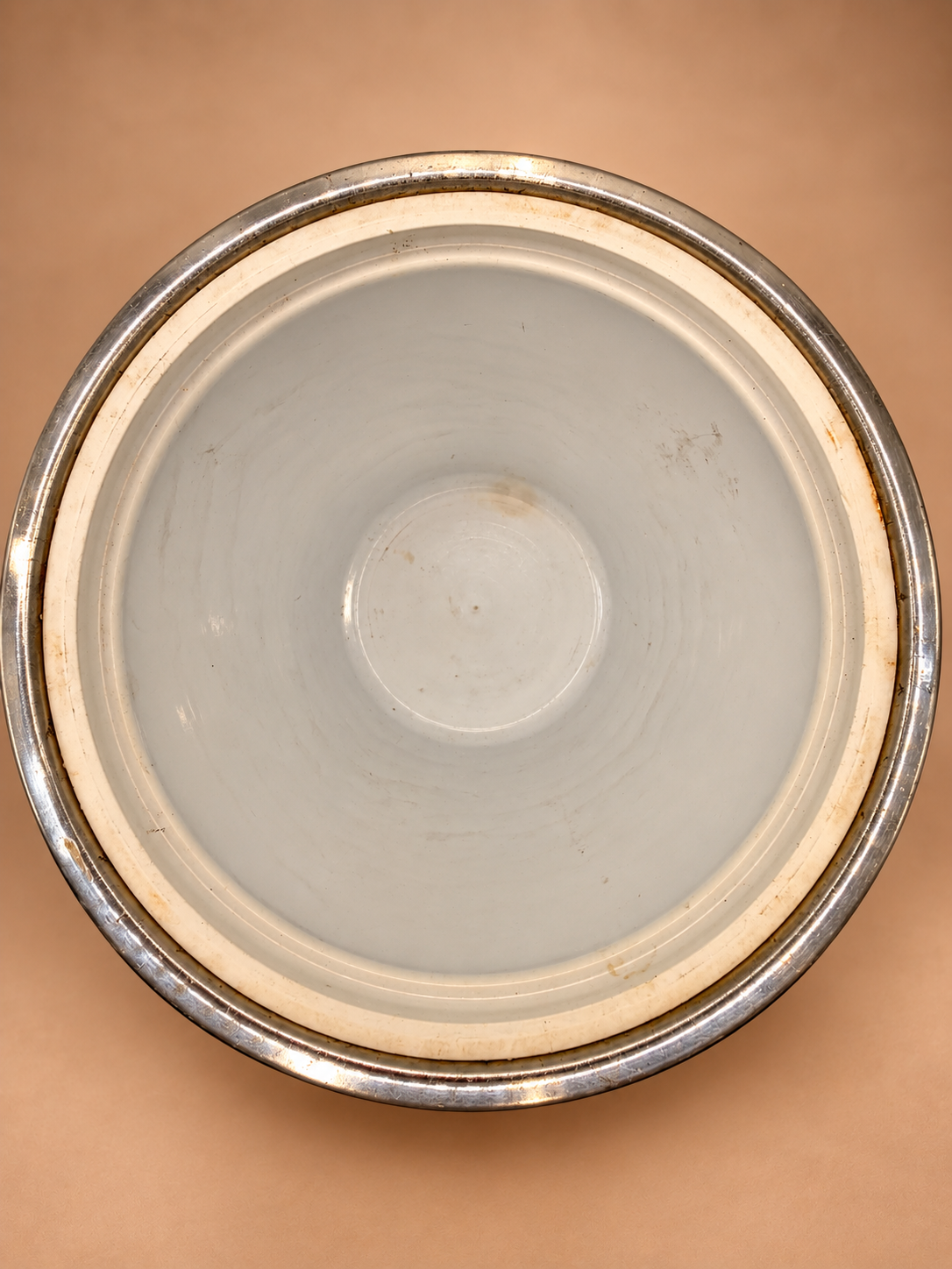 Overhead view of vintage Kraftware ice bucket showing white insulated interior with age-appropriate marks and discoloration.