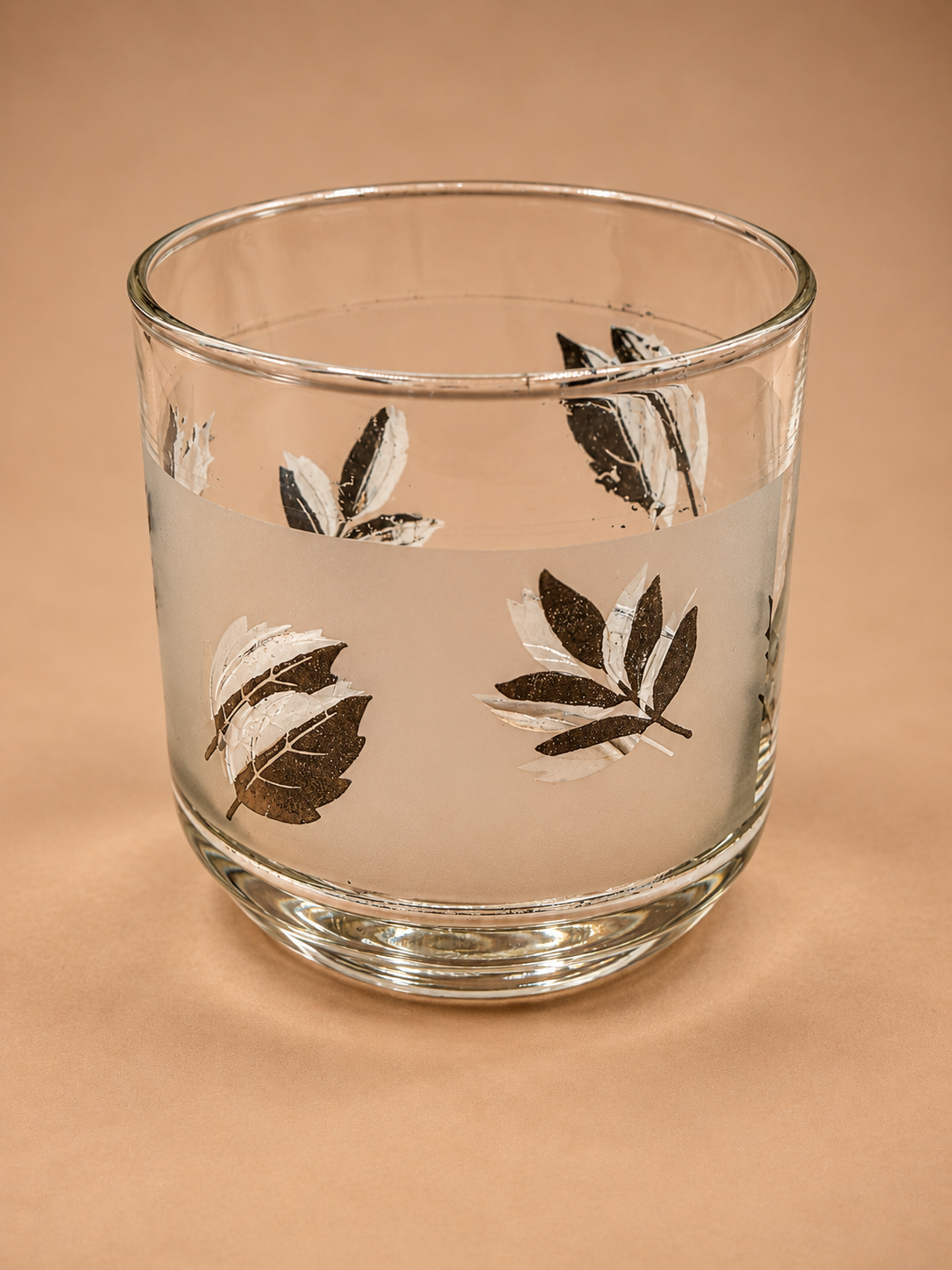 Vintage Libbey old fashioned glass with frosted band and assorted metallic silver botanical leaf motifs.