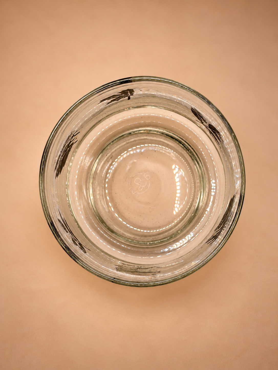 Bottom view of vintage Libbey Silver Leaf rocks glass showing clear glass inside and rim.
