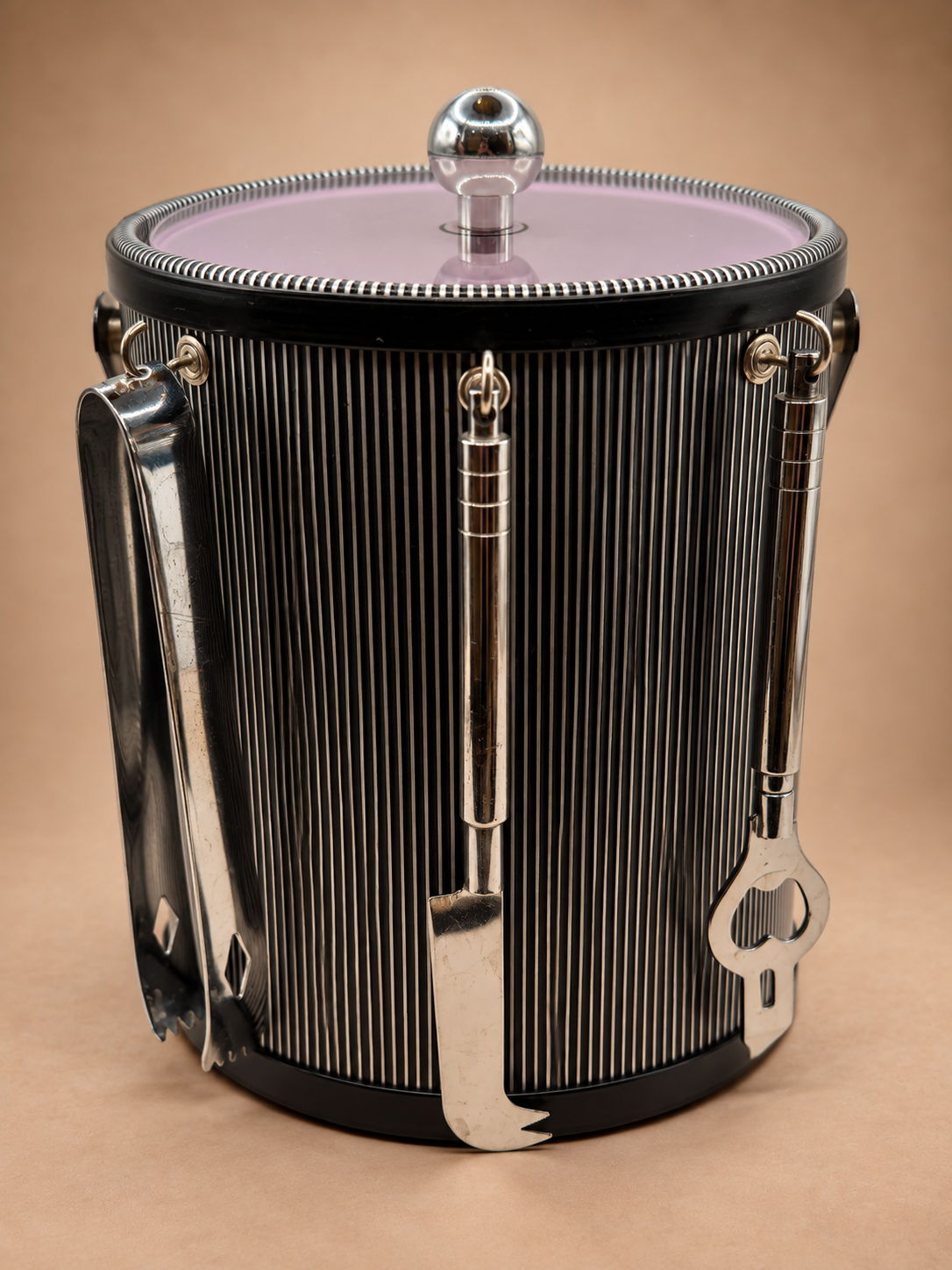 Vintage midcentury black and silver striped ice bucket with tinted lid and hanging silver-tone cocktail bar tools.