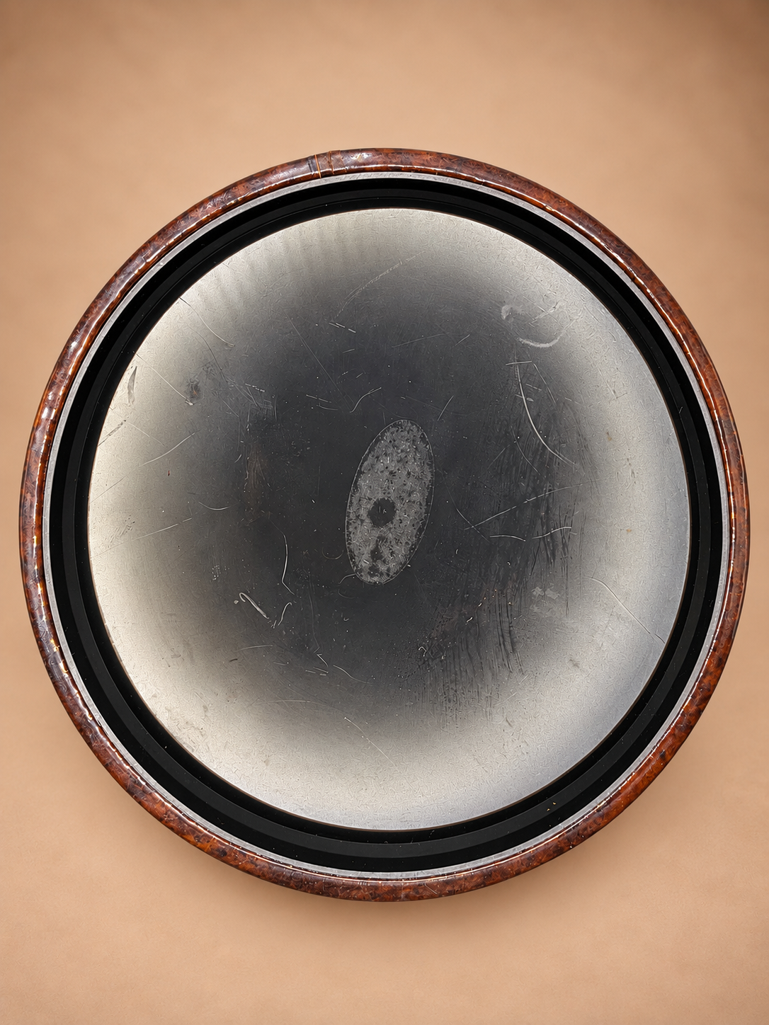 Bottom view of vintage midcentury ice bucket showing metal base and brown tortoiseshell-style outer edge.