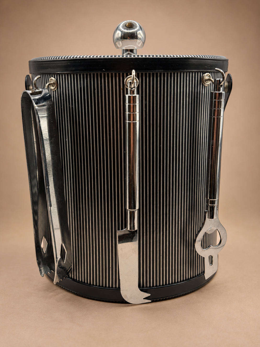 Vintage black and silver striped ice bucket with coordinating hanging tongs, opener and silver-tone cocktail tools.