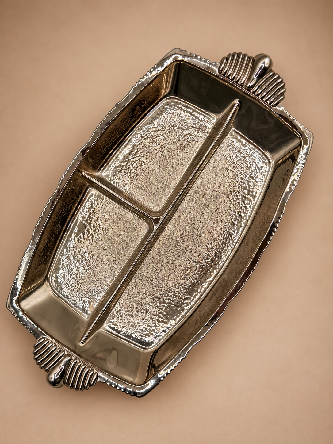 Vintage three-section divided glass relish dish with reflective silver-tone finish, textured glass and ribbed handles.