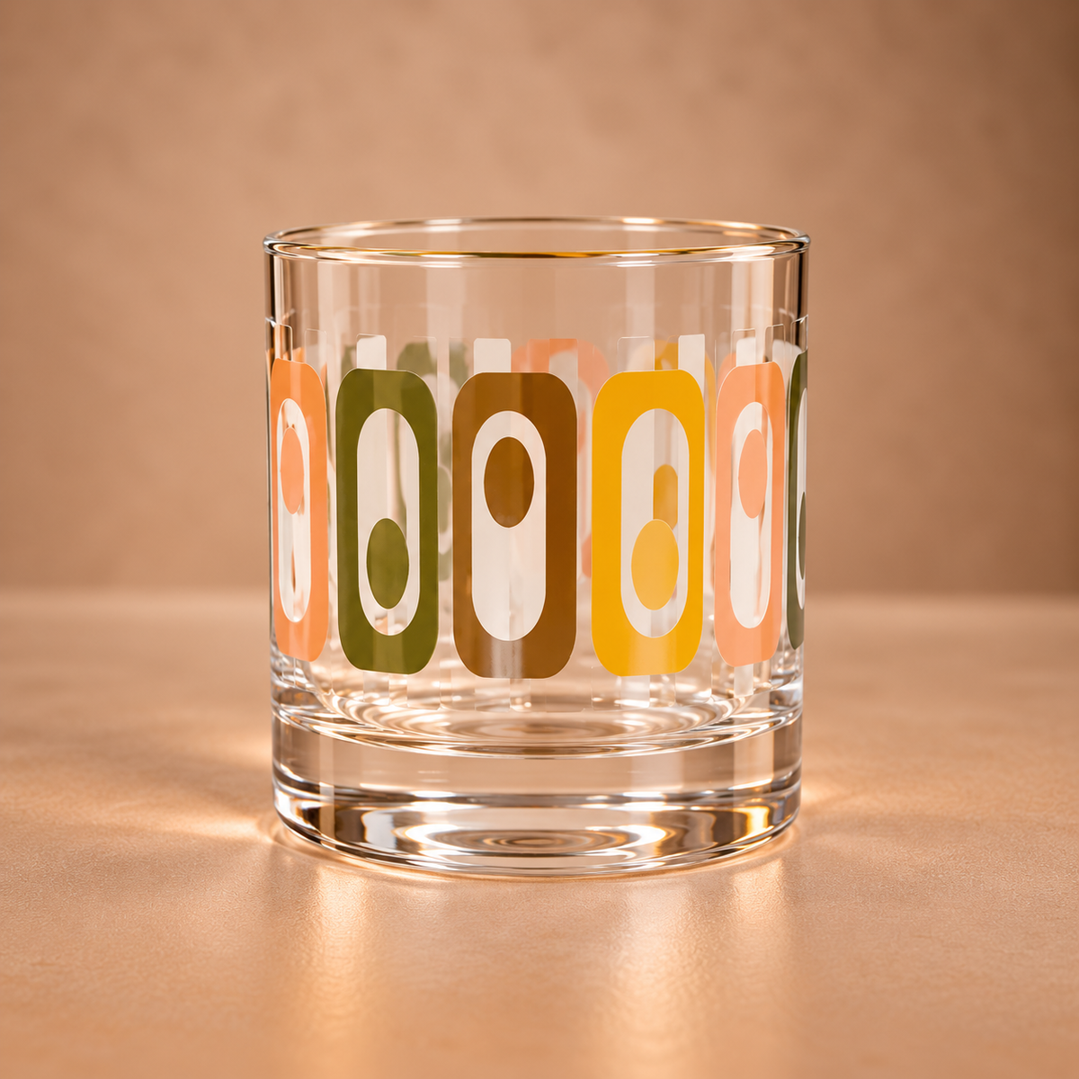 Vintage-inspired tiki whiskey rocks glass featuring a retro geometric pattern in orange, peach, green and brown