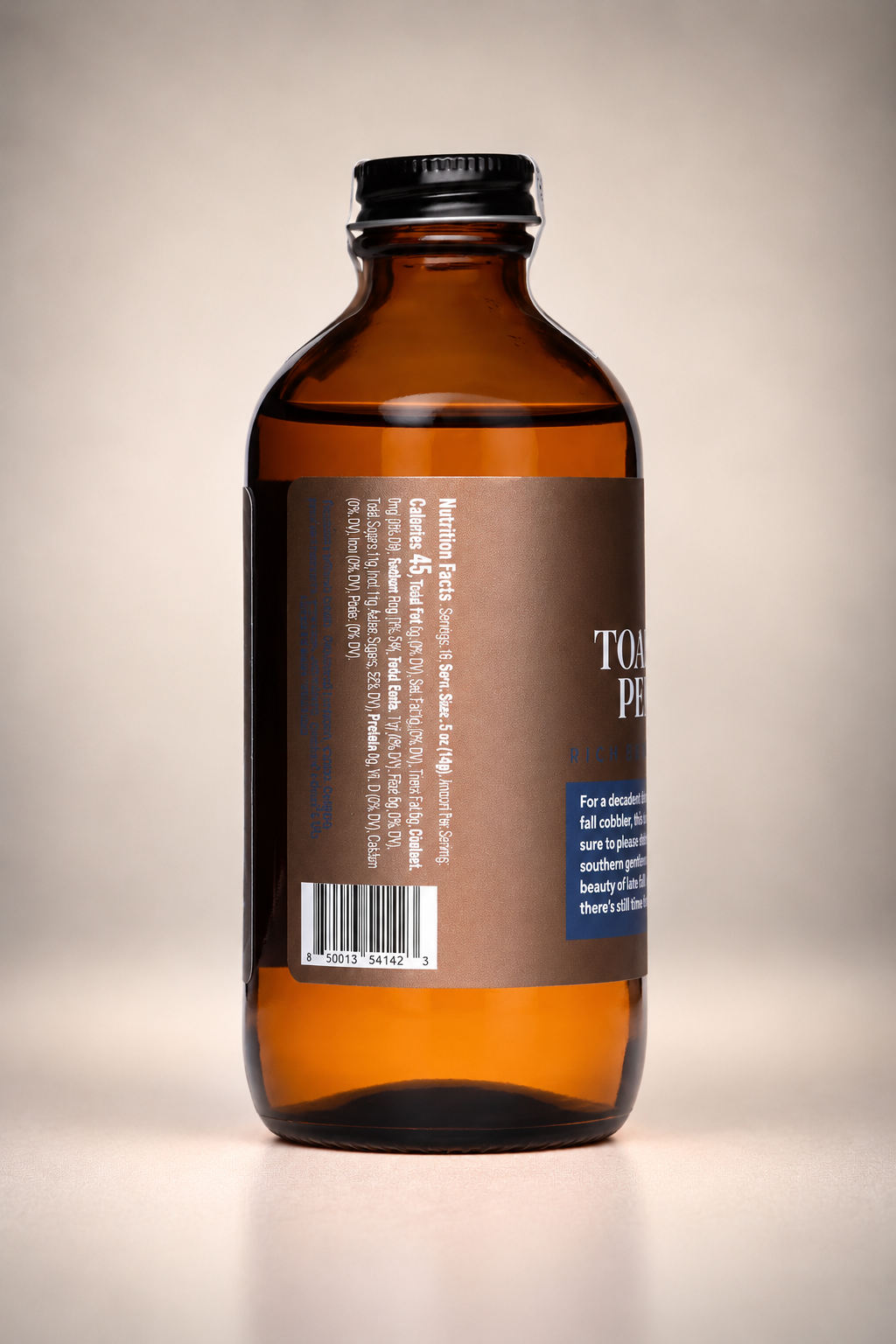 Side view of Toasted Pecan Cocktail Syrup bottle showing nutrition facts and product barcode on the brown label of the 8 oz amber glass bottle.