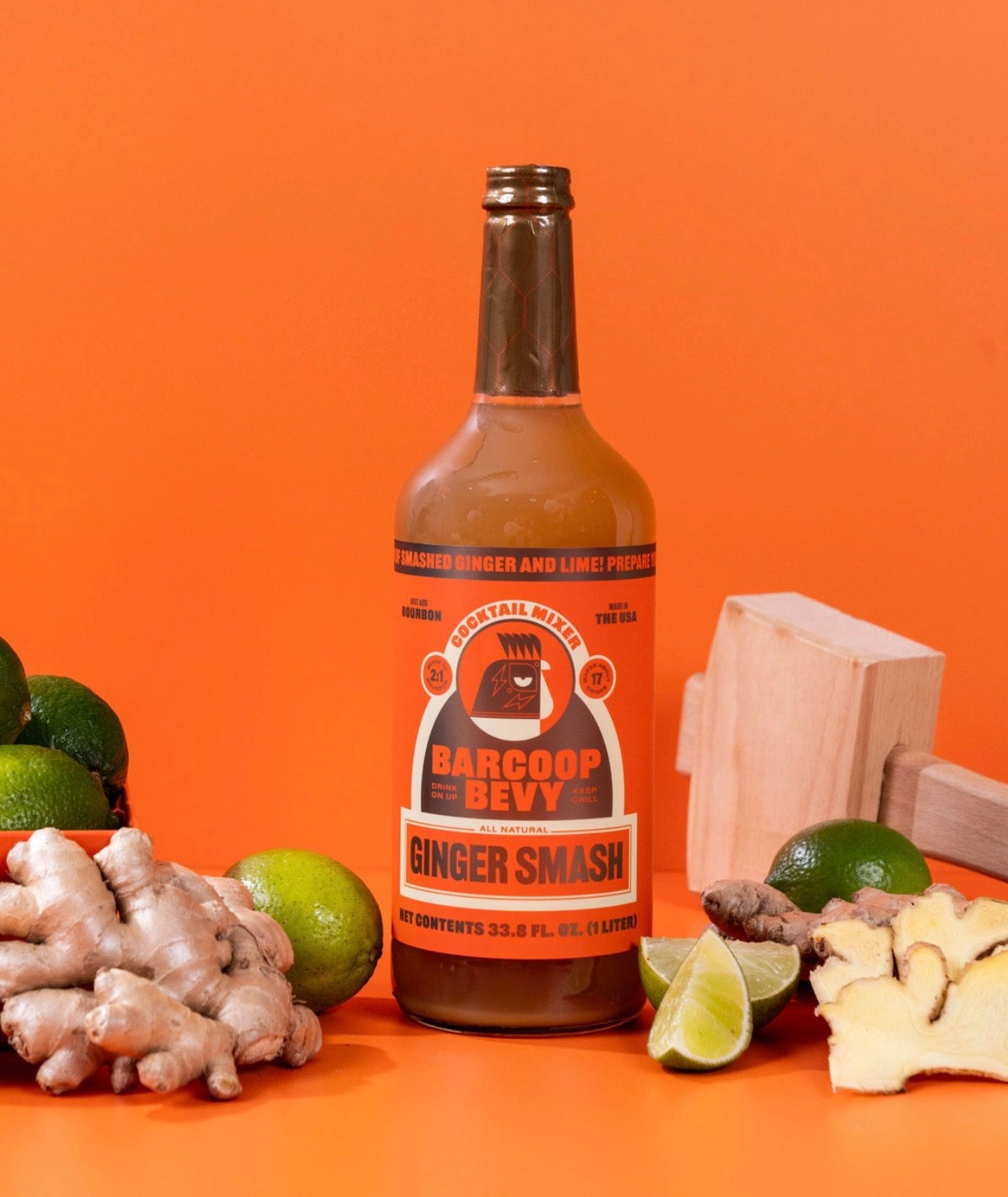 Barcoop Bevy ginger smash mixer with fresh ginger root and lime on orange background
