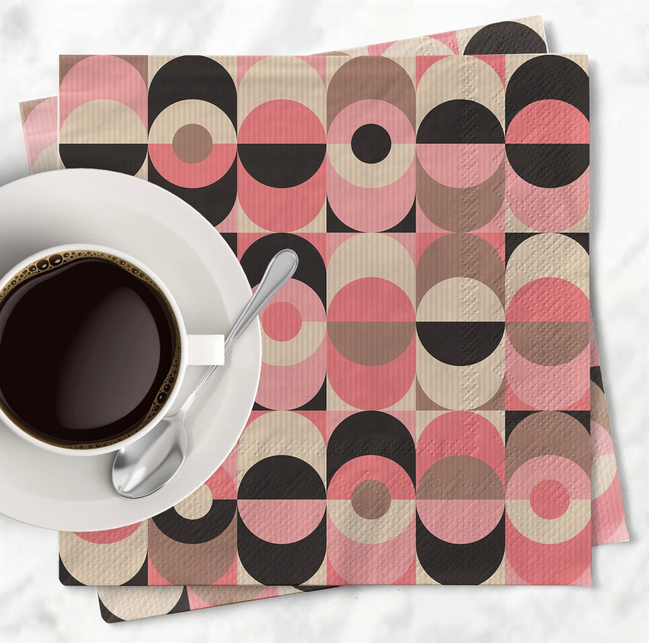 Pink retro cocktail napkins styled with white coffee cup on marble background