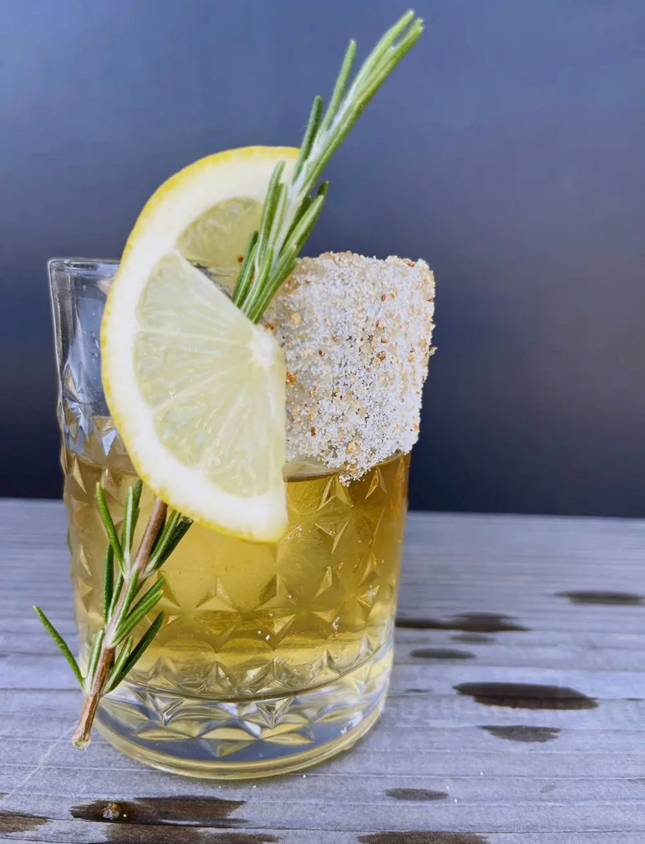 Whiskey cocktail with citrus spice sugar rim and lemon garnish using Twilight Party Cocktail Sugar.