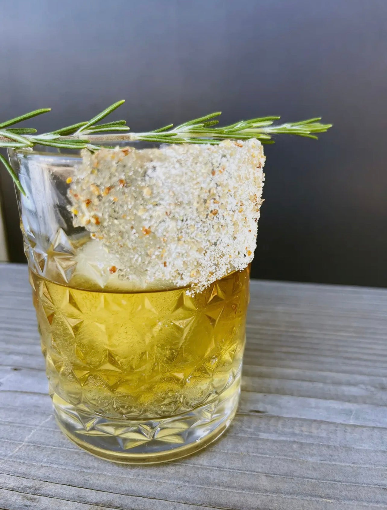 Cocktail with citrus spice sugar rim and rosemary garnish using Twilight Party Cocktail Sugar.
