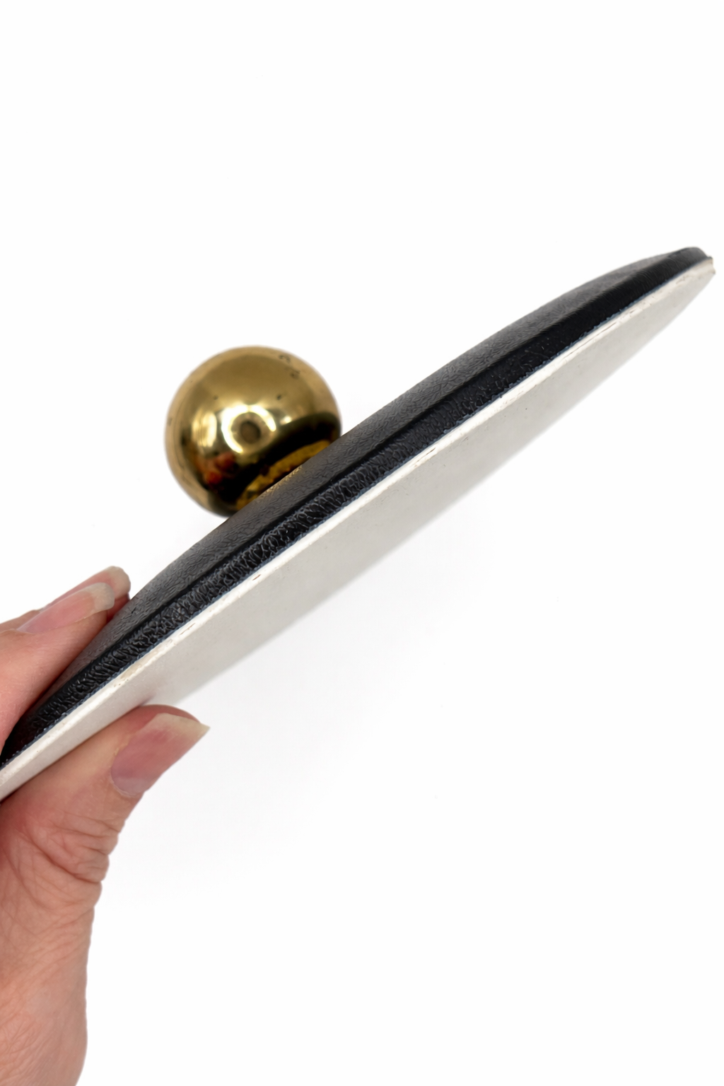 Side profile of Courroc ice bucket lid showing textured black exterior and white interior.