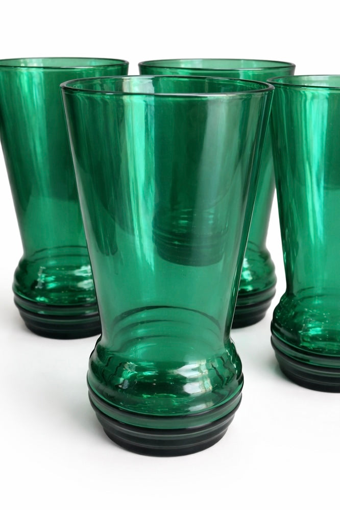 Close up detail of emerald green vintage cocktail glasses with sculpted base