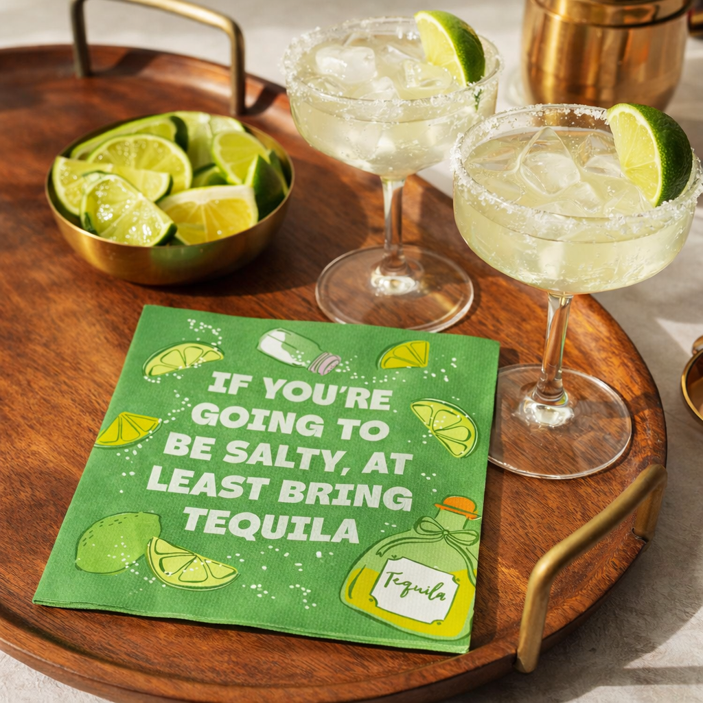 Funny tequila cocktail napkin styled on mid century modern tray with margaritas and limes