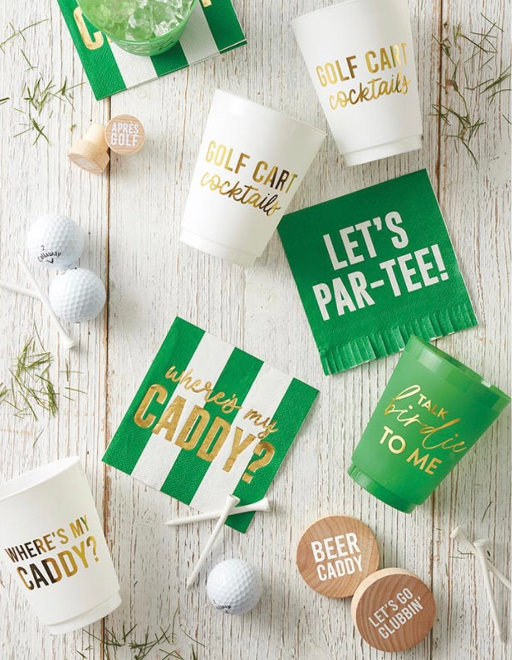Golf themed party setup with Golf Cart Cocktails cups, golf napkins, tees, golf balls, and drink accessories