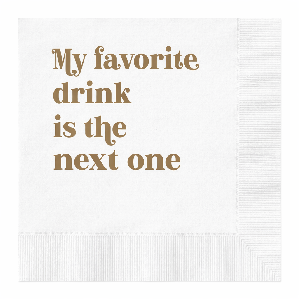 White cocktail napkin with gold foil text reading My Favorite Drink Is the Next One