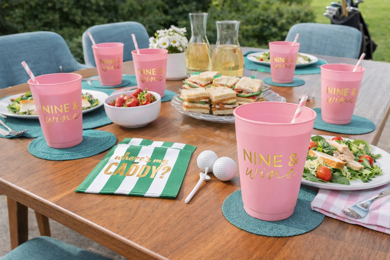 Nine & Wine pink reusable cups styled on a mid century modern golf luncheon table with sandwiches and drinks.