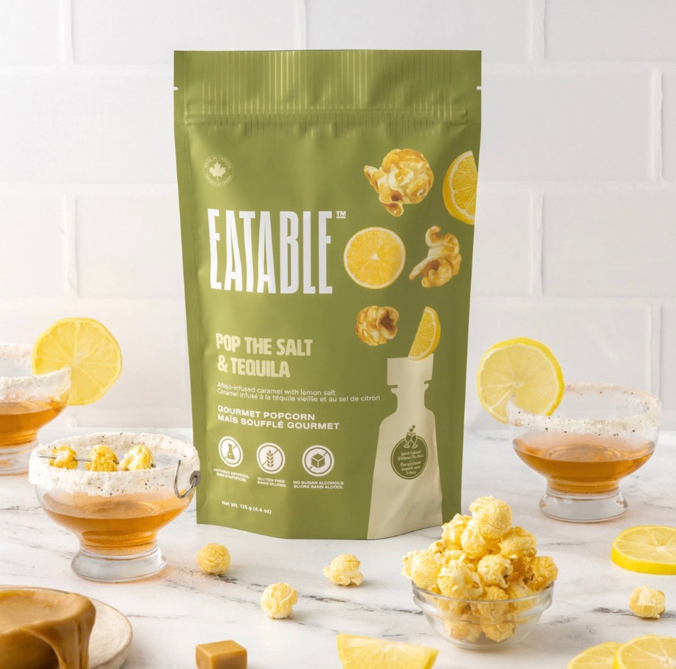 Eatable Pop the Salt and Tequila gourmet popcorn bag styled with cocktails, lemon slices, and popcorn