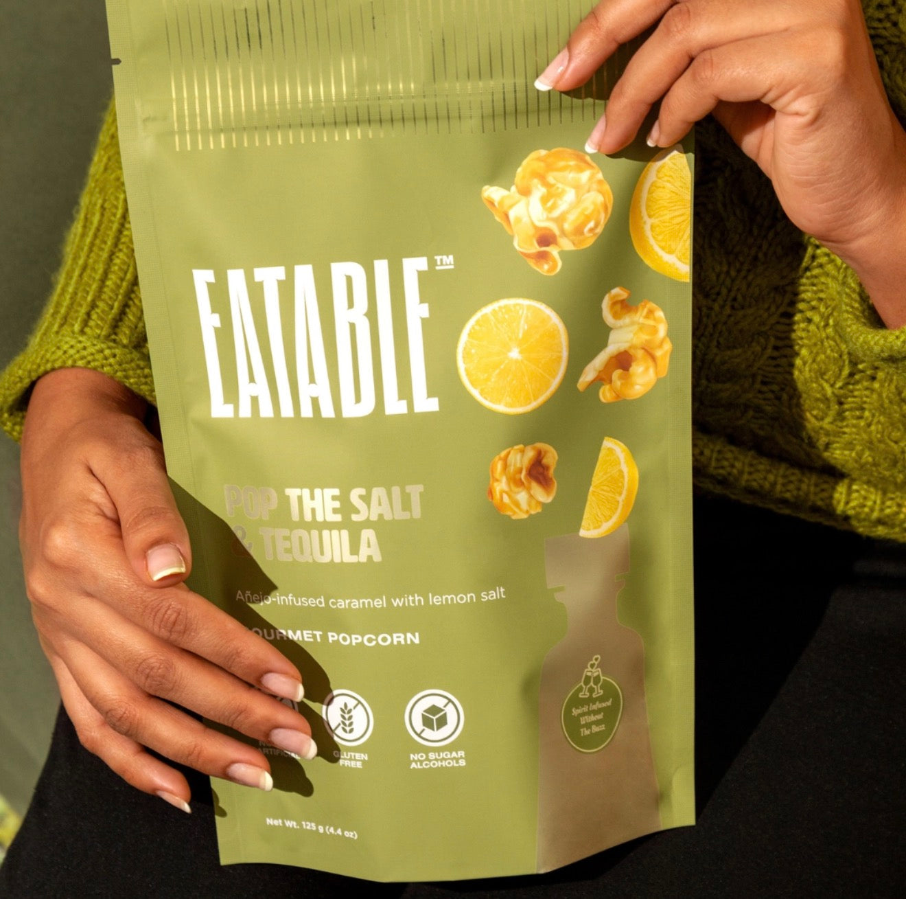 Person holding Eatable Pop the Salt and Tequila gourmet popcorn bag outdoors