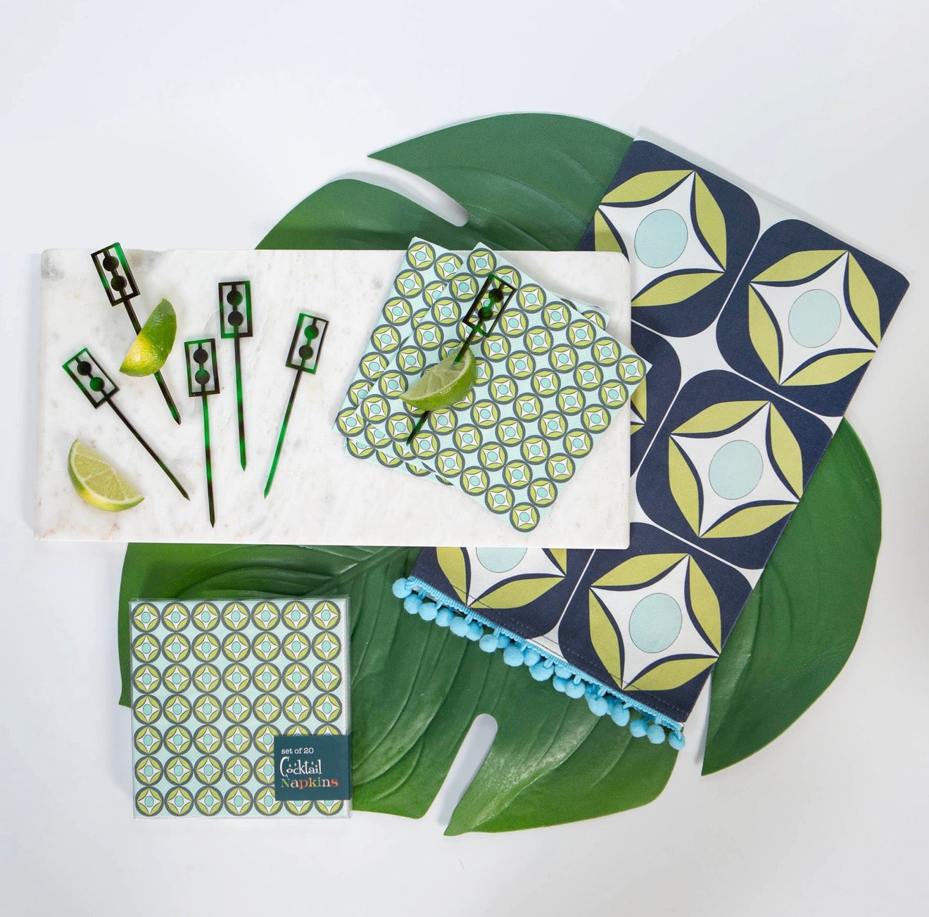 Blue raindrop circle cocktail napkins styled with matching tea towel and cocktail picks.