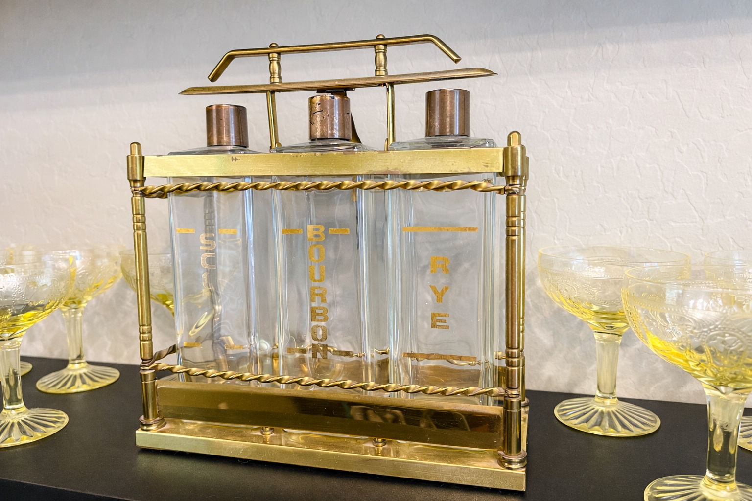 Mid century brass liquor decanter set styled with vintage coupe glasses