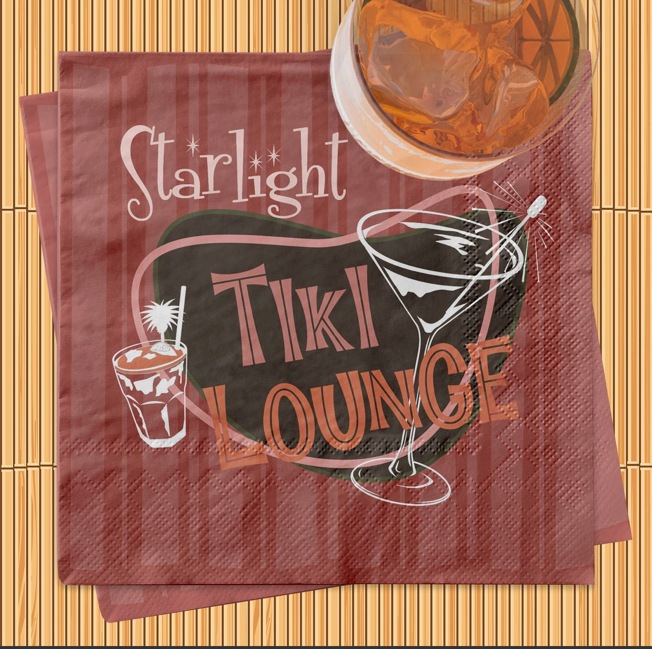Retro tiki cocktail napkin styled with iced cocktail on bamboo-inspired background