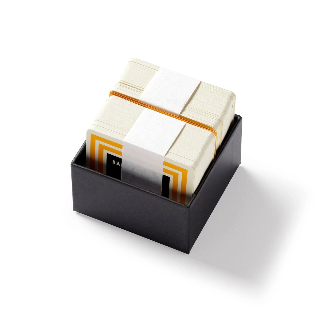 Trivial Drinking Trivia game cards neatly stacked inside the black storage box, a compact party game gift for cocktail lovers.