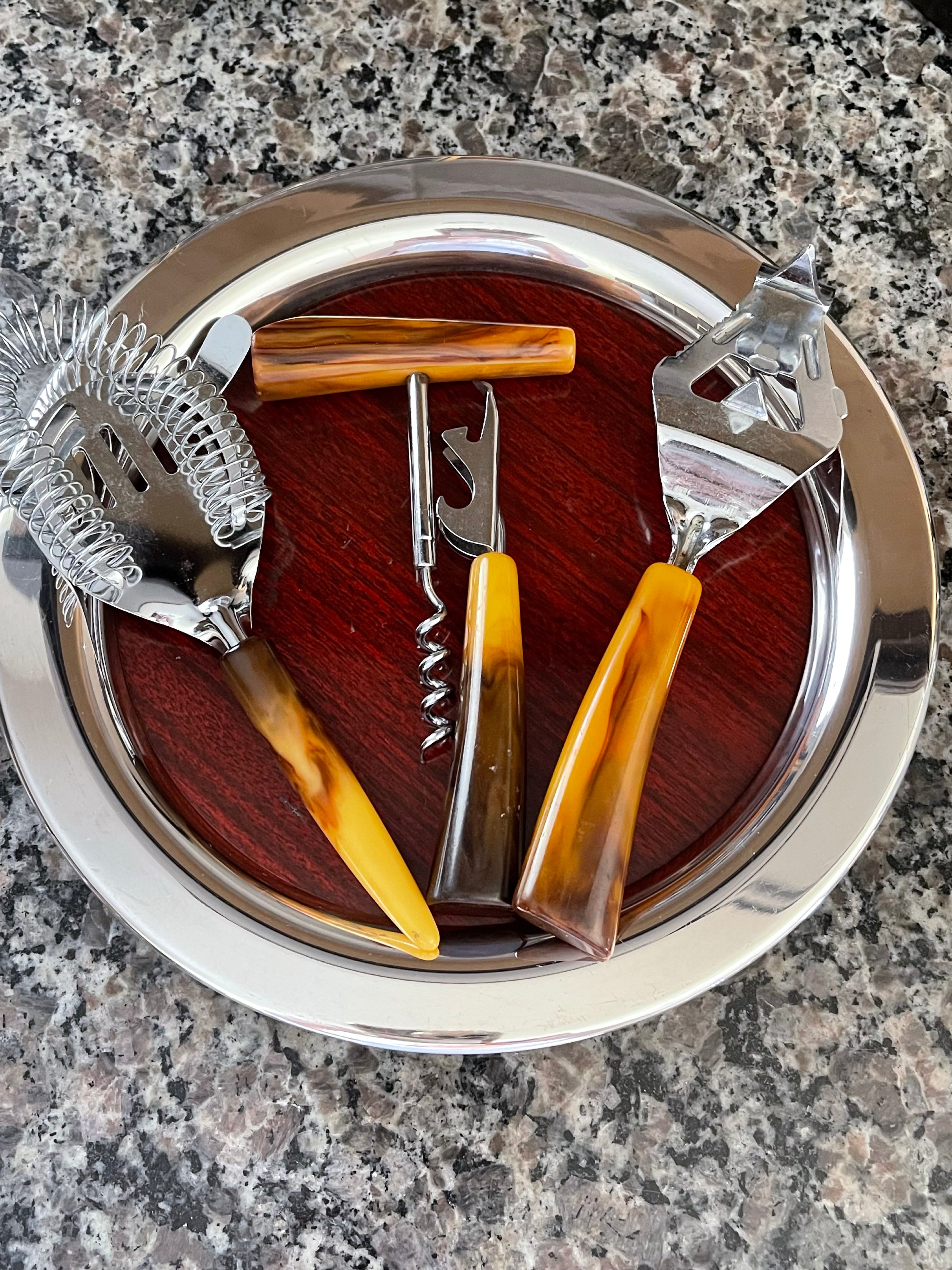 Vintage Bakelite barware tools displayed on wood and chrome serving tray