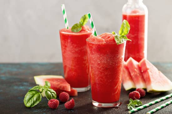 Examples of finishe watermelon slushies in tall glasses garnished with fresh watermelon and mint