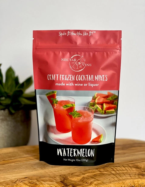 Package of watermelon flavored cocktail mix that can be made with wine or liquor displayed on a wood table