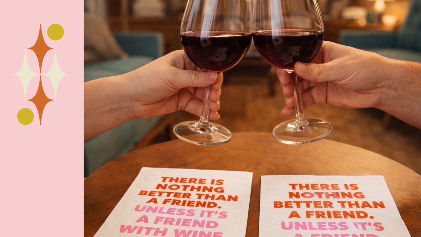 Two people toasting red wine glasses above playful cocktail napkins on a table – thoughtful host and hostess gift idea