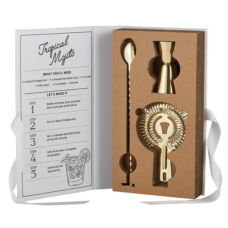 stainless steel barware set in gold finish includes bar spoon, jigger, and cocktail strainer. The inside cover of the gift box features a recipe for a tropical mojito.
