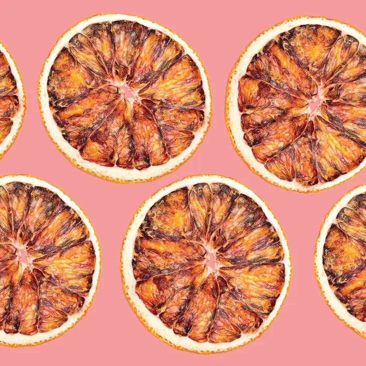 dehydrated blood oranges displayed against a pink background