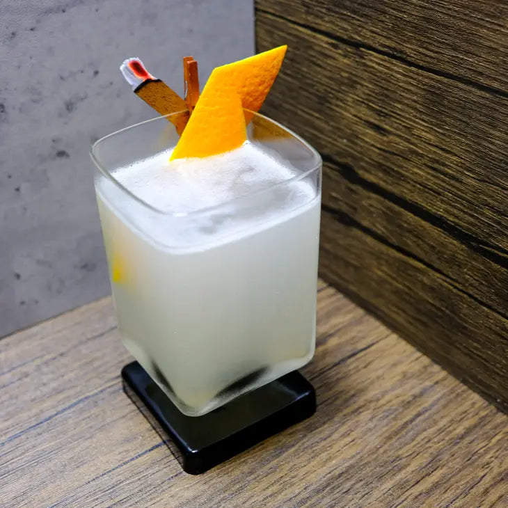 cocktail cedar and orange peel garnish a drink