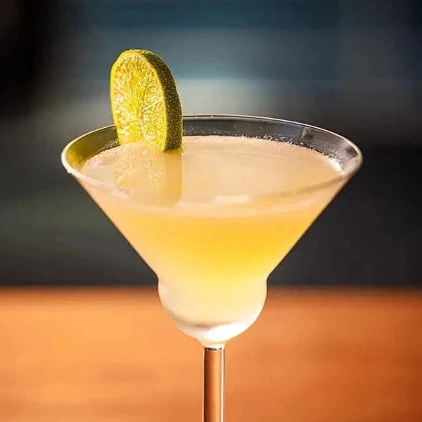 Yellow cocktail garnished with citrus 