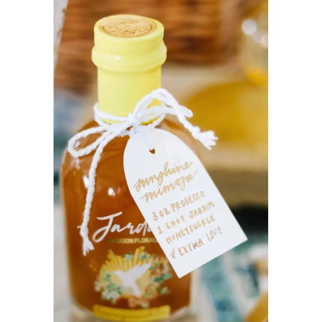 bottle of Jardin Premium Honeysuckle mixer with a gift tag tied around the top as a shower favor