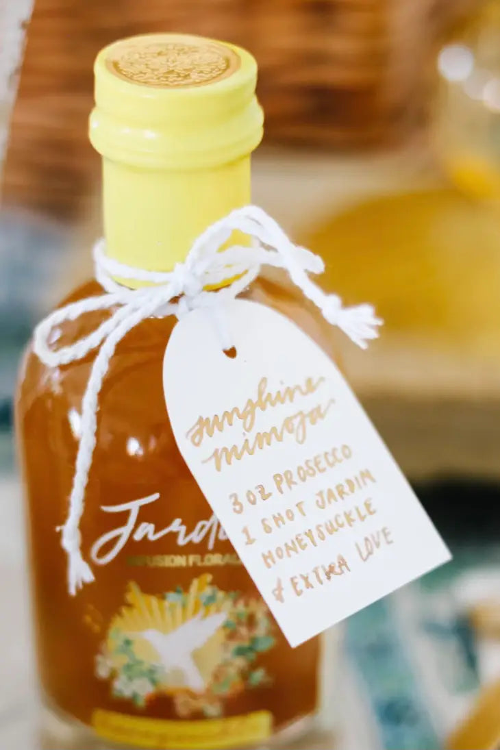 bottle of Jardin Premium Honeysuckle mixer with a gift tag tied around the top as a shower favor