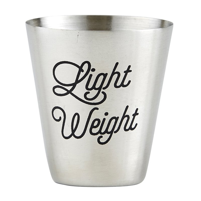 close up of stainless steel shot cup with "Light Weight" etched into the cup